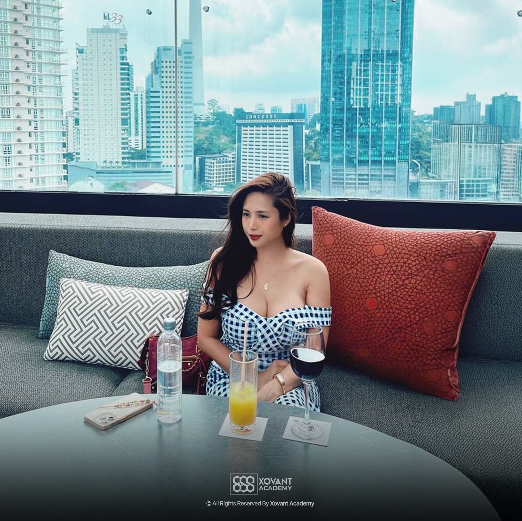 Dr Ilizah seated in a Kuala Lumpur lounge overlooking the city
